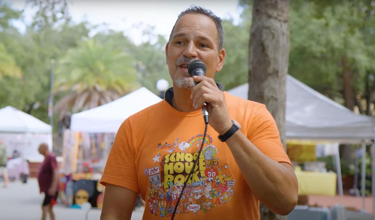 Man on a microphone at the Ybor market