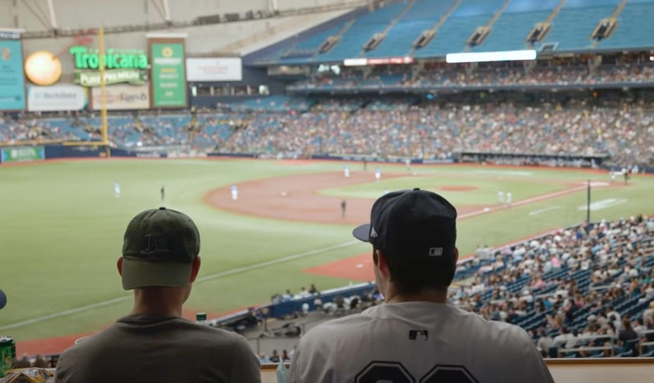 View from behind two men watching a baseball game at Tropicana Field