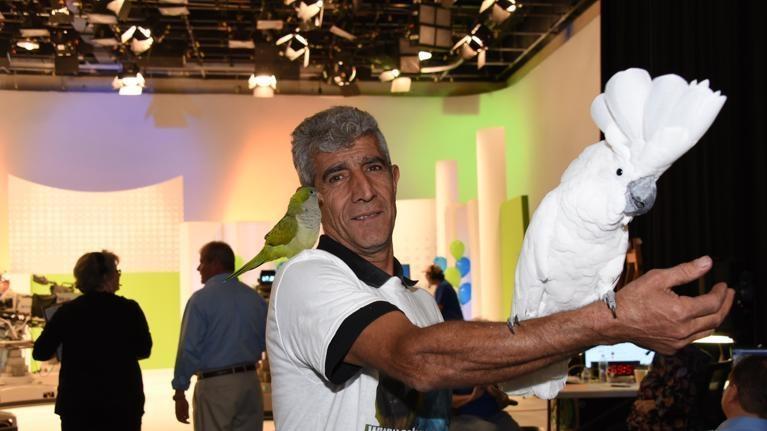 Man holding various birds in a WEDU PBS Studio