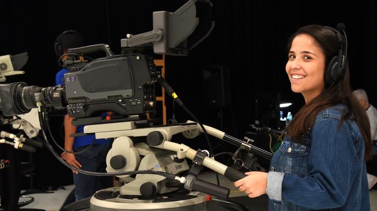 Woman using a camera in a WEDU PBS studio.