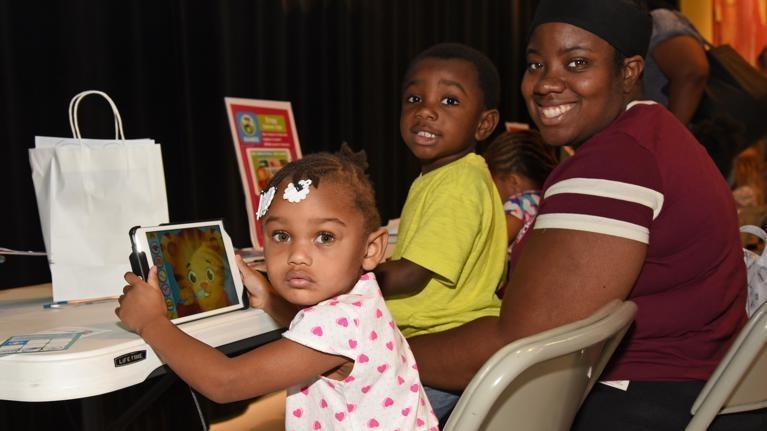 Kids playing PBS Kids apps on an IPAD at an event