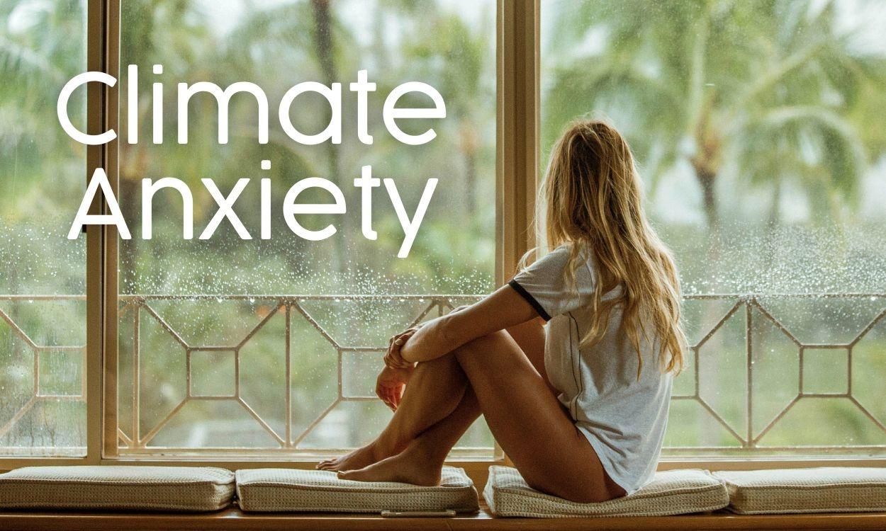 Woman looking out a large window into a storm