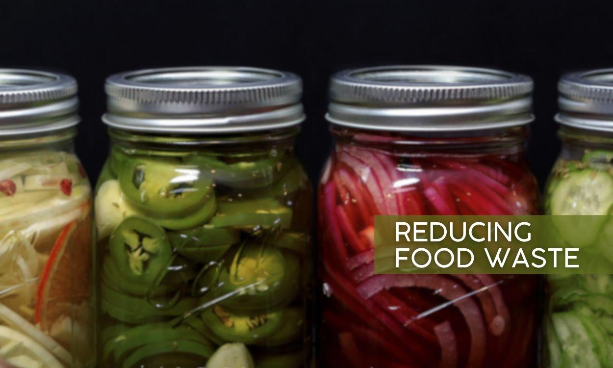 Four mason jars filled with pickled veggies