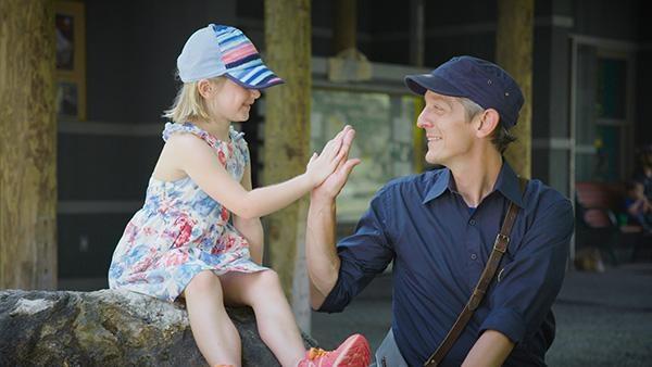 Mister Chris high fiving a young girl