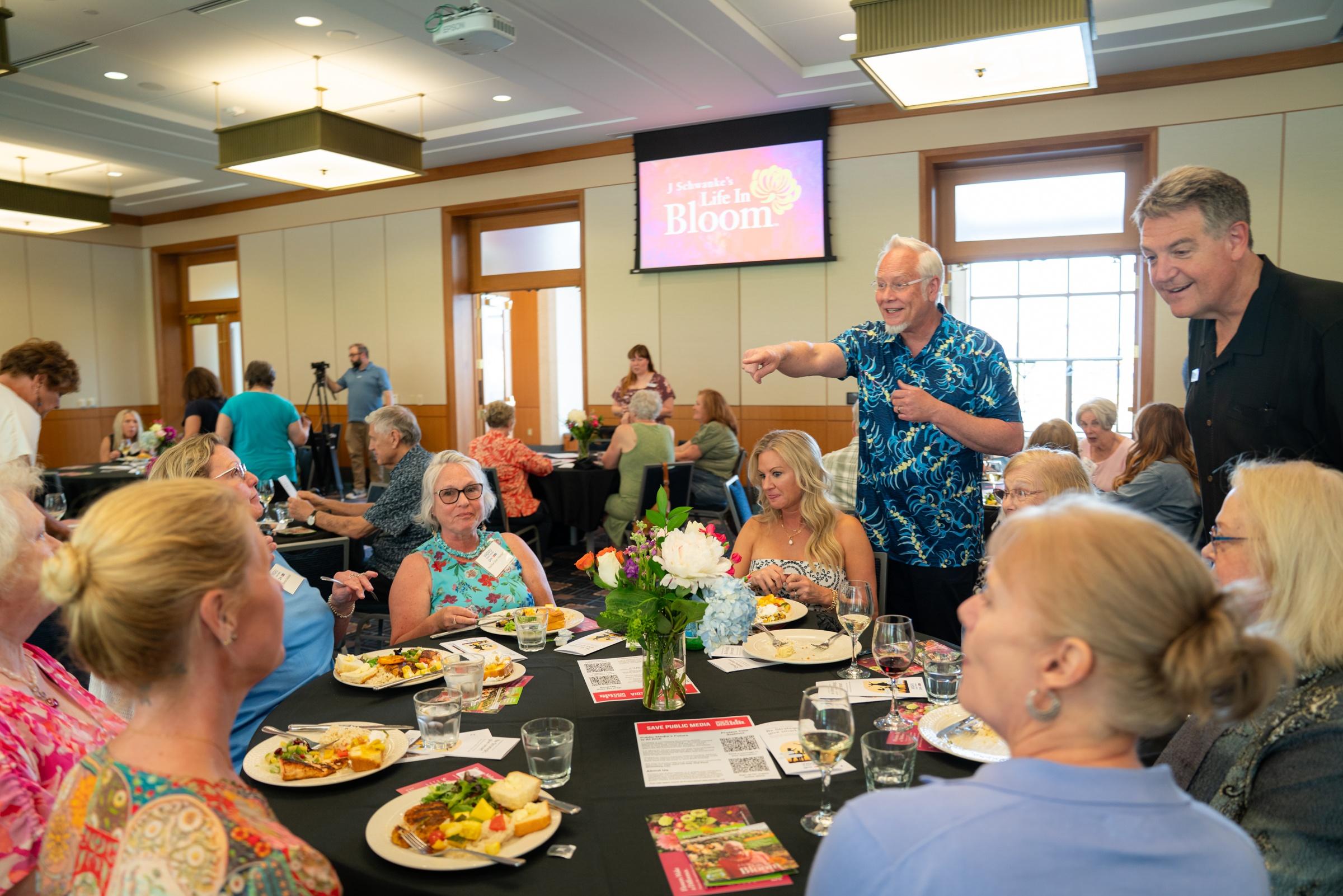 J Schwanke excitedly points at an attendee of a Life in Bloom event