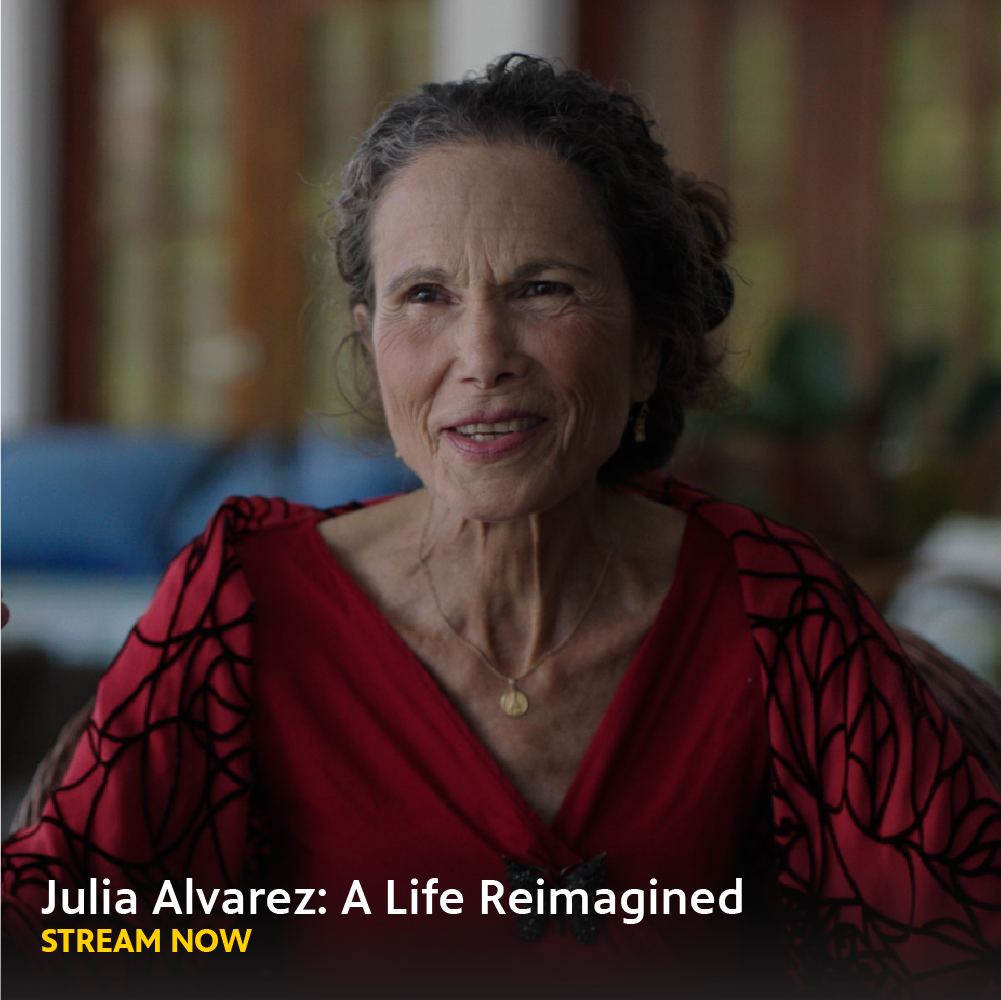 Headshot of an older Latina woman in vibrant red dress. Reads, "Julia Alvarez: A Life Reimagined Stream Now". 