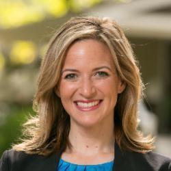 jocelyn benson wearing a blazer and smiling at the viewer