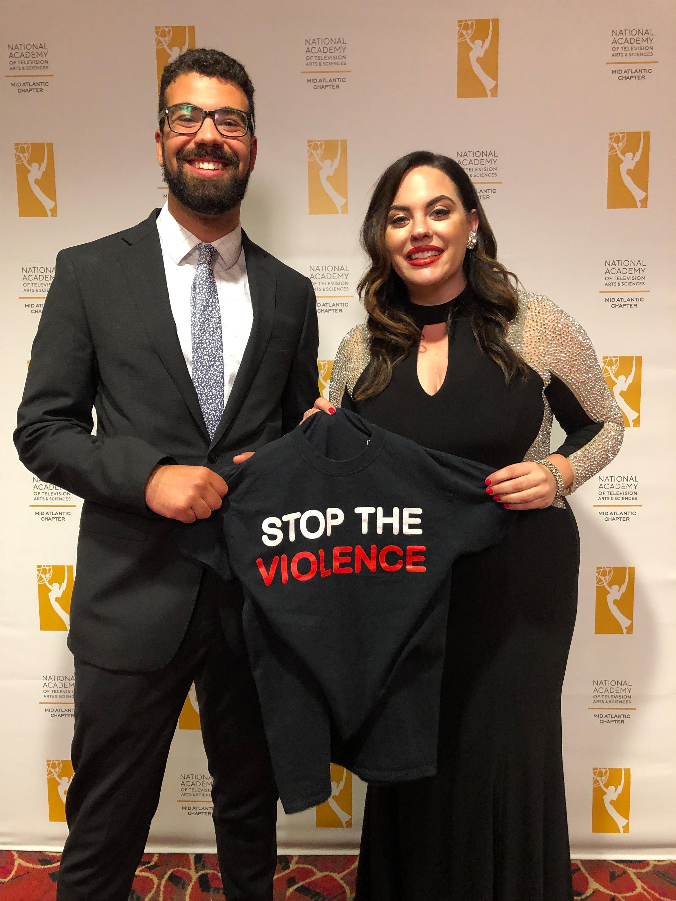 PBS39's Daniel Ray and Megan Frank hold up a shirt in honor of the subject of their Emmy-nominated report. 