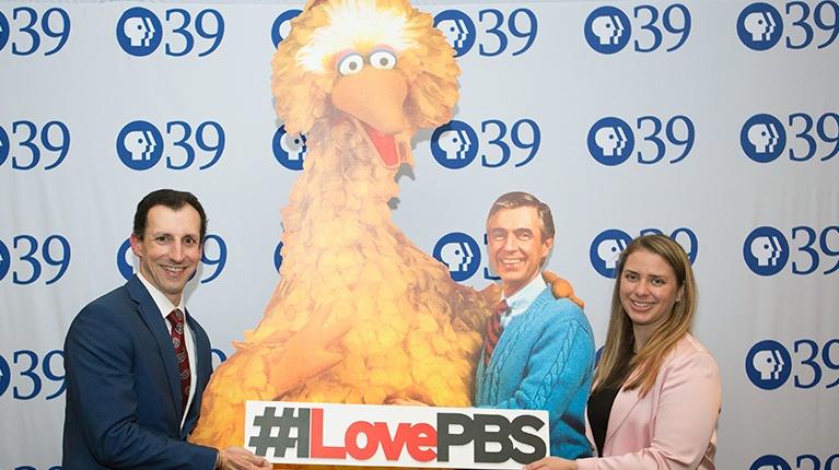 Become a Member - Photo is our two young members pictured with cardboard cutouts of Big Bird and Mister Rogers