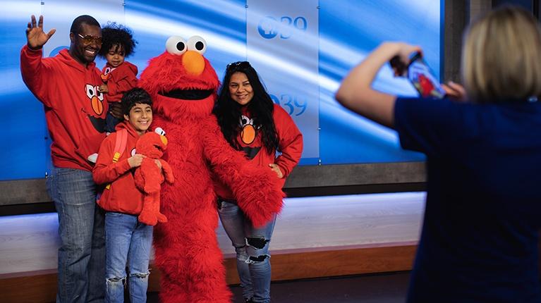 Update Your Information - Photo shows a family with Elmo