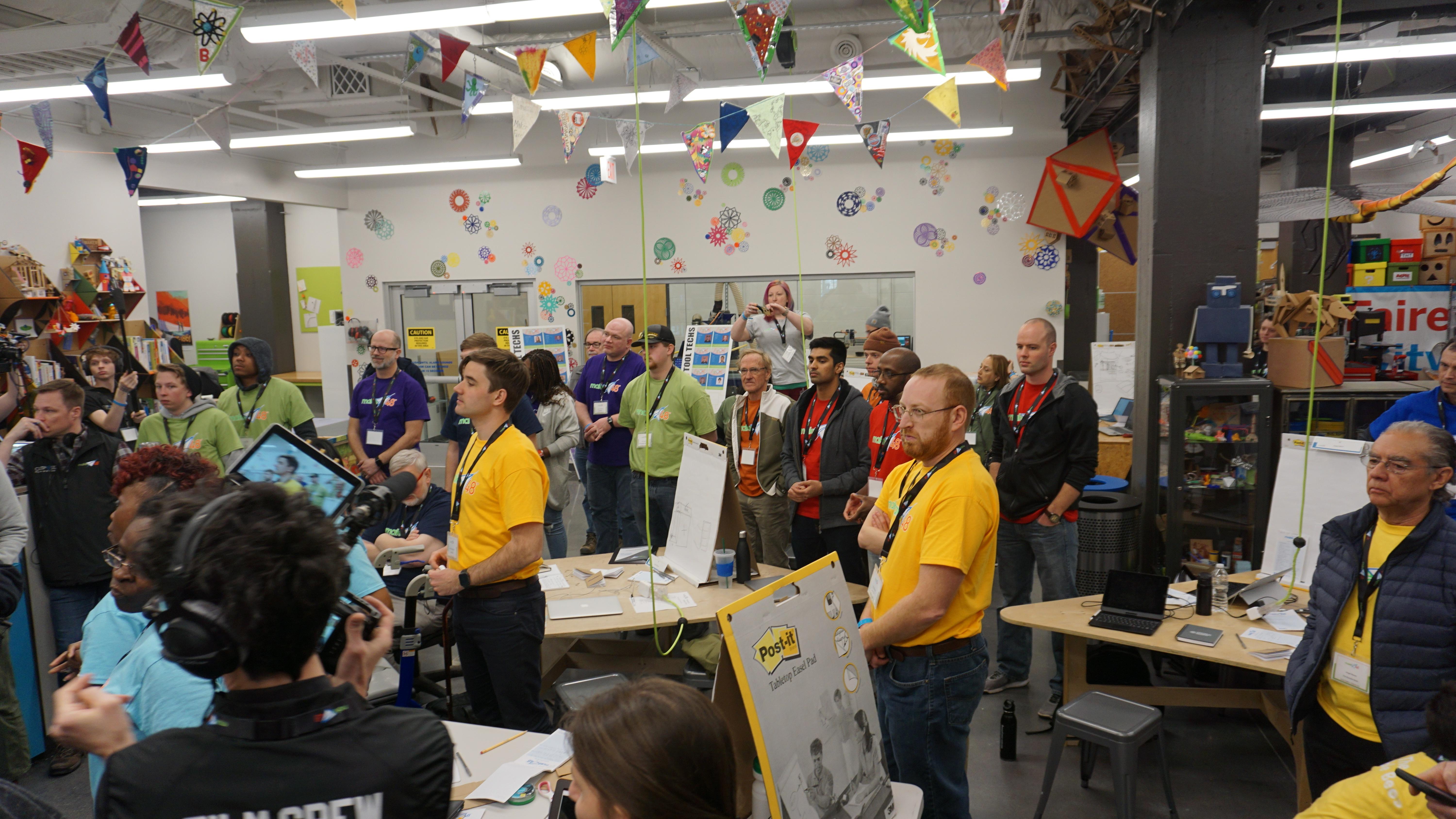 Photo of Makerspace with a room of people with colorful shirts