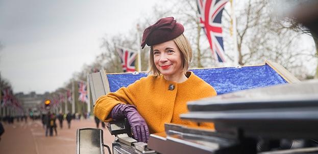 Lucy Worsley in a carriage on The Mall, London.