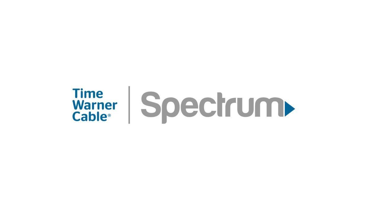 The Time Warner Cable logo in a blue sans serif font on three lines with the Spectrum logo in a gray sand serif font to the right.