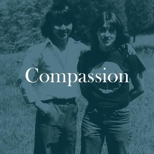The word "Compassion" is displayed in white, serif, type on a dark green transparent overlay with a photo of Jana posing for a photo with a friend standing next to her with their arm resting on her shoulder.