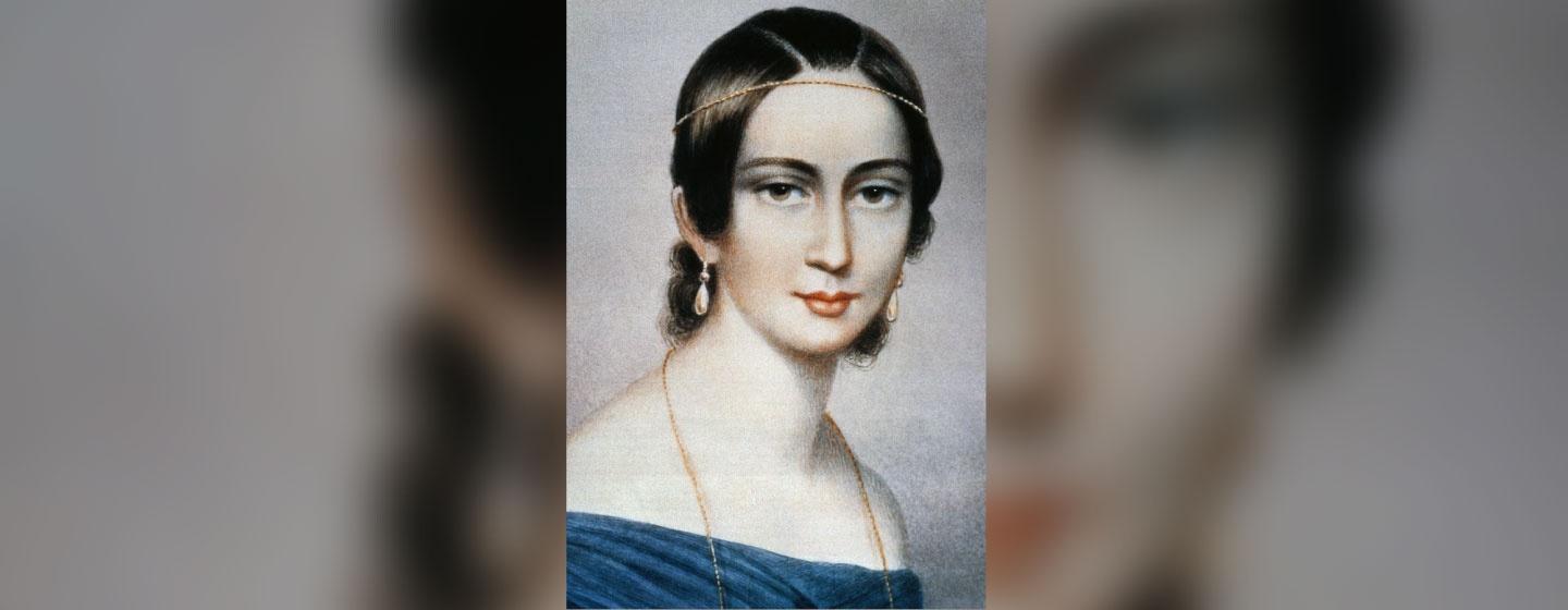 A painting of a young Clara Schumann wearing a blue dress and a gold necklace