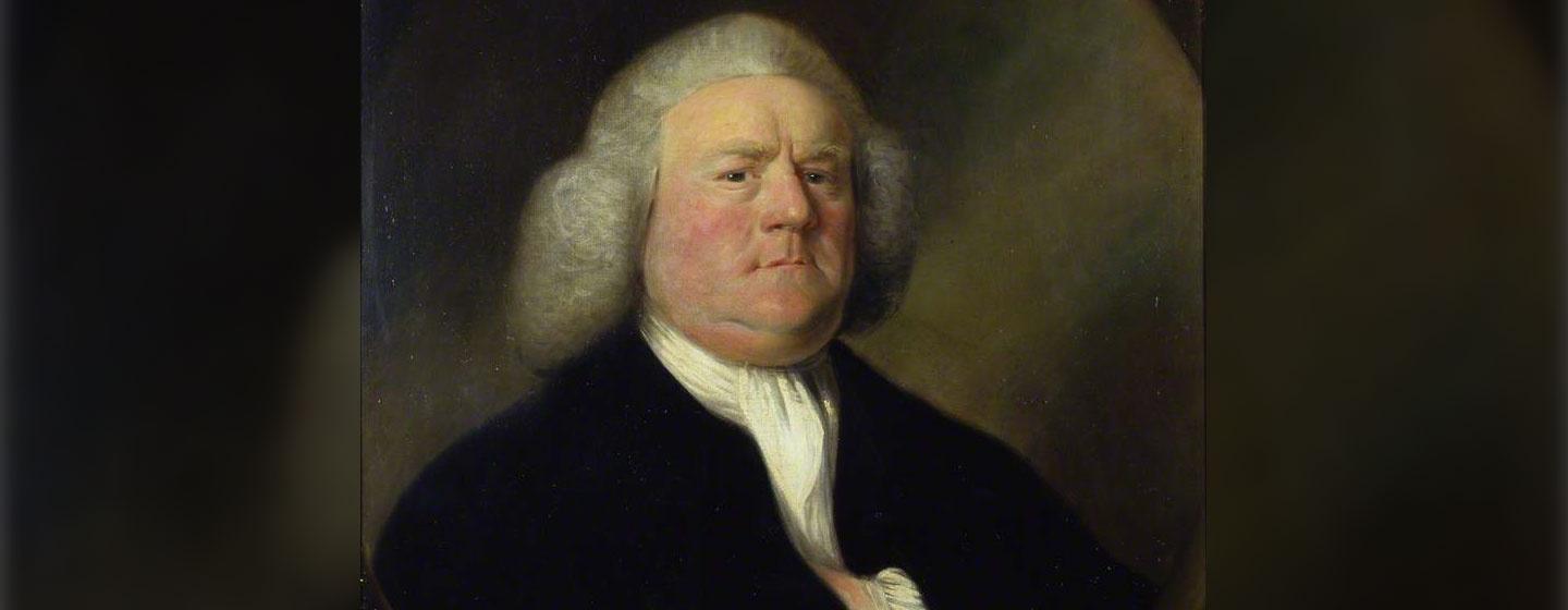 English Composer/Organist William Boyce poses to have his portrait painted while wearing dark clothing and his left hand ticked inside of his coat.