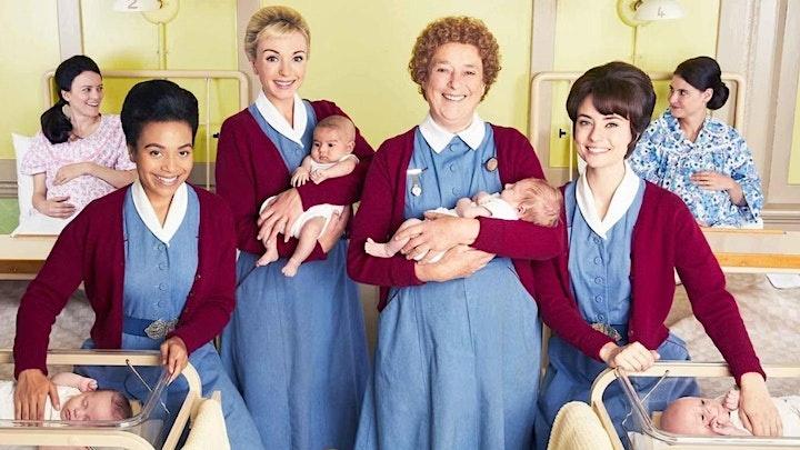 Cast of Call the Midwife smiling at the camera, holding 2 babies