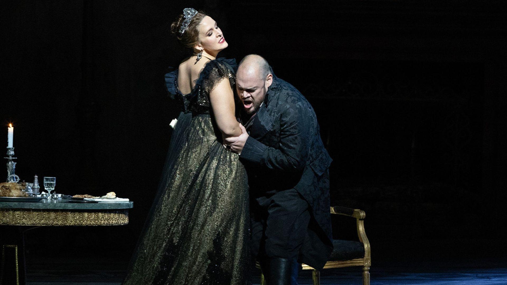 A scene from "Tosca" where a man is collapsing in a woman's arms