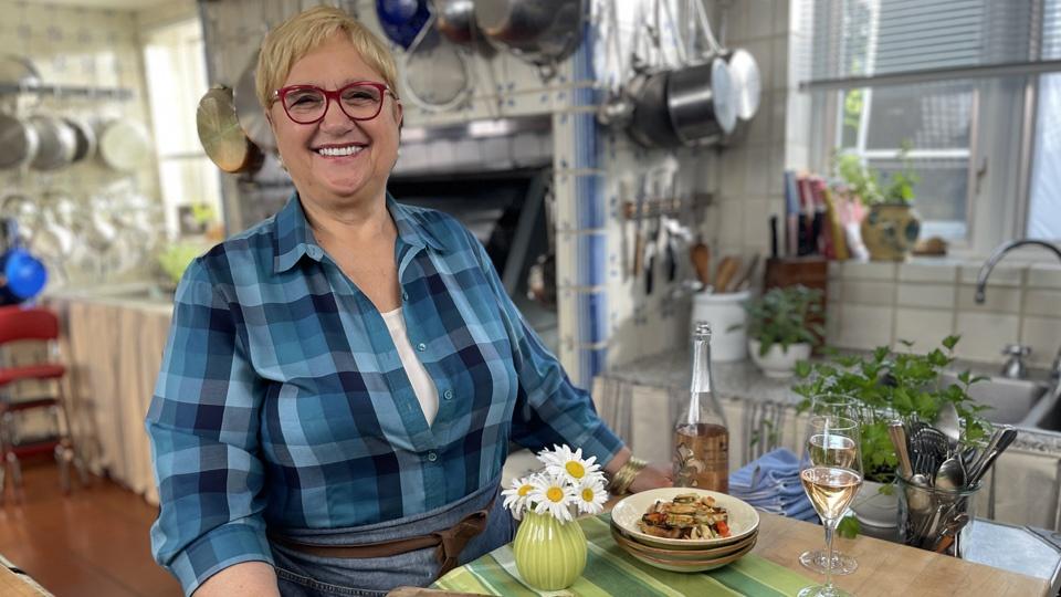 Lidia holding a tray and smiling