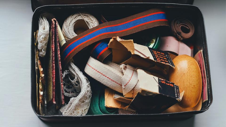 An opened, tin sewing box