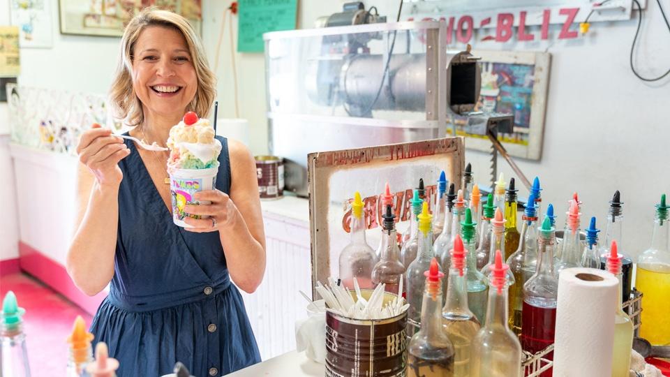 Samantha Brown holding up a very large ice cream sundae