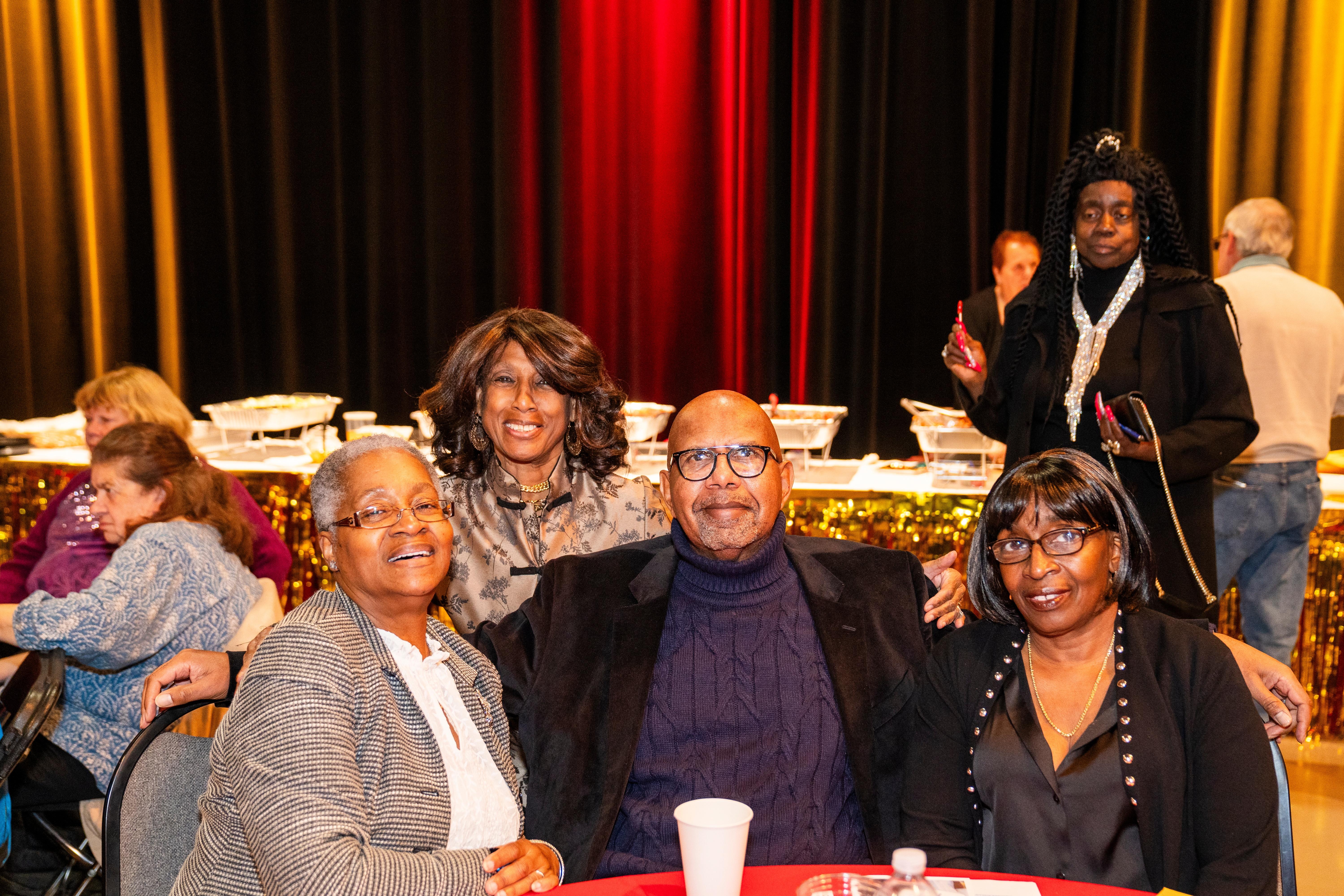 Photo of 4 people seated at their table