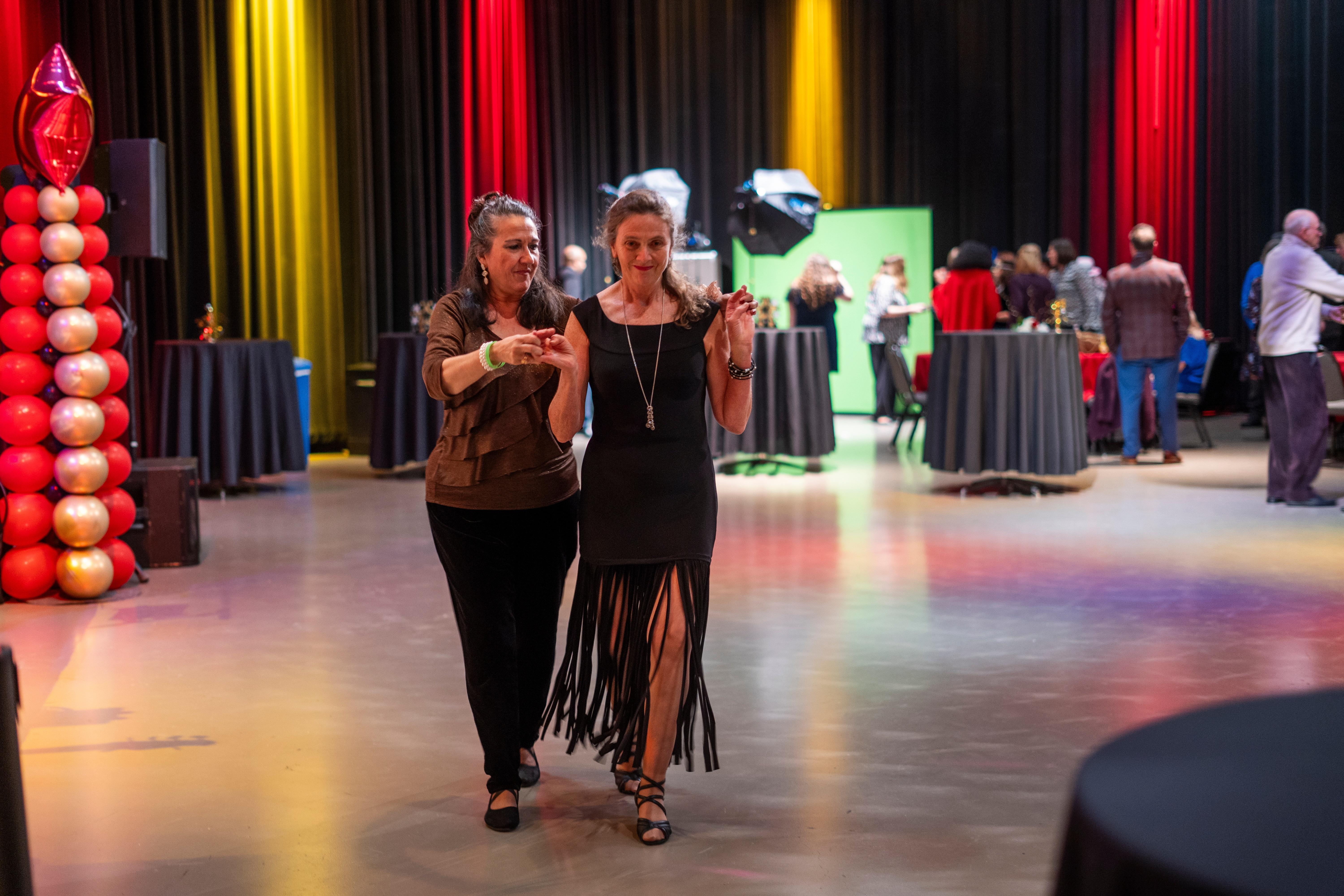 Two women walking back to their seats