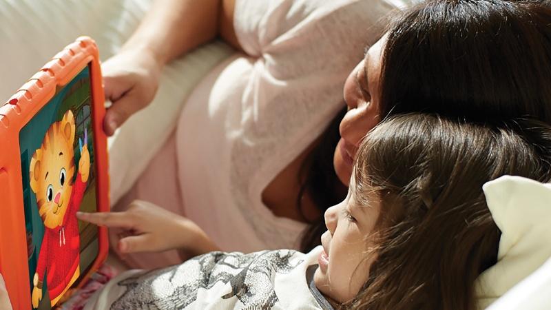 mom and daughter looking at Daniel Tiger on an ipad