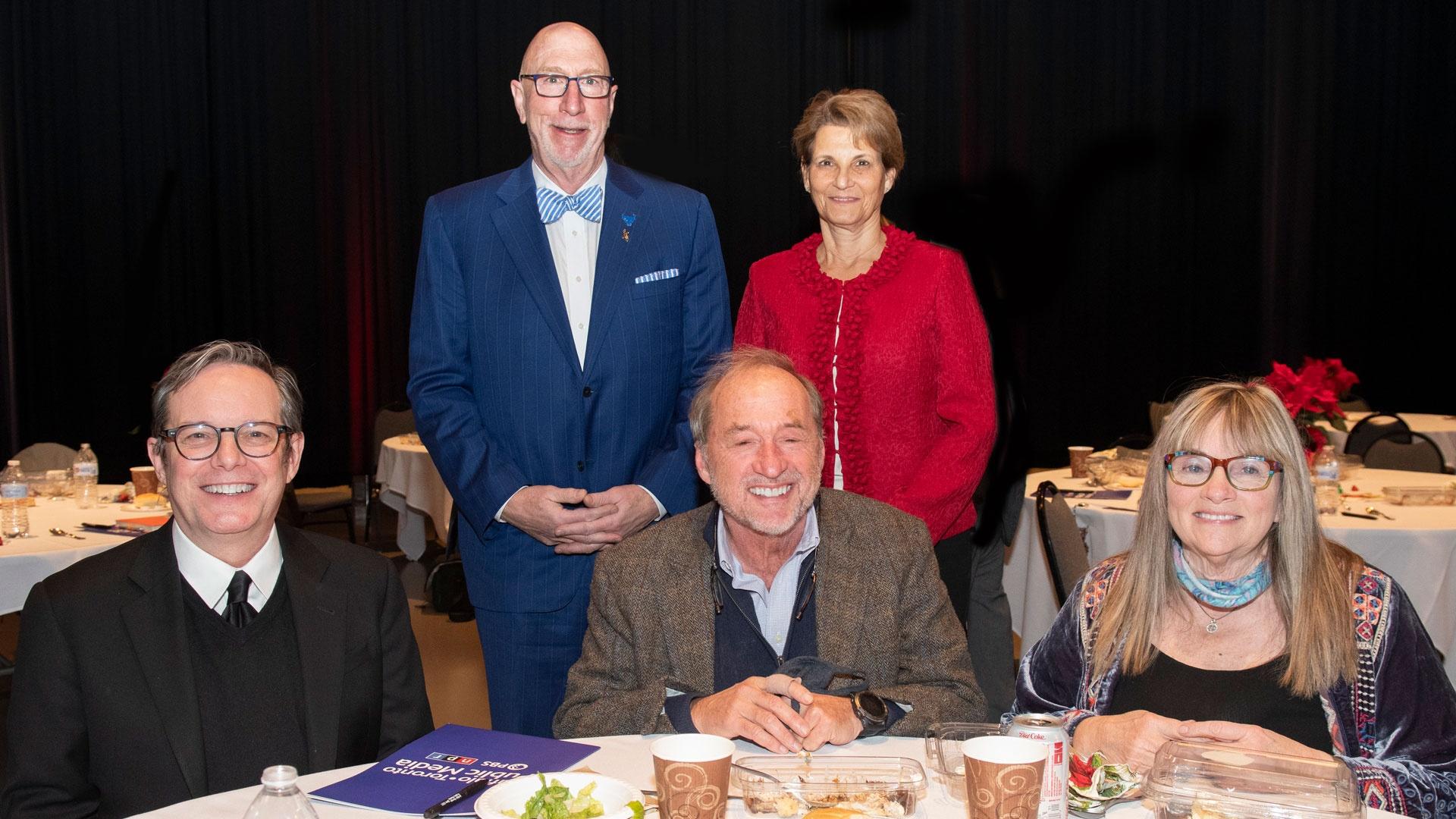 Drs. Phillip Glick and Drucy Borowitz (standing) along with Stephen Still and Terry Tucker (seated) enjoy meeting new President and CEO Tom Calderone (far left)