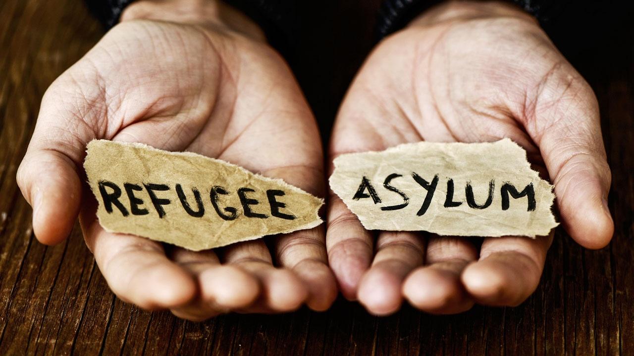 What is the difference between a refugee and an asylee?