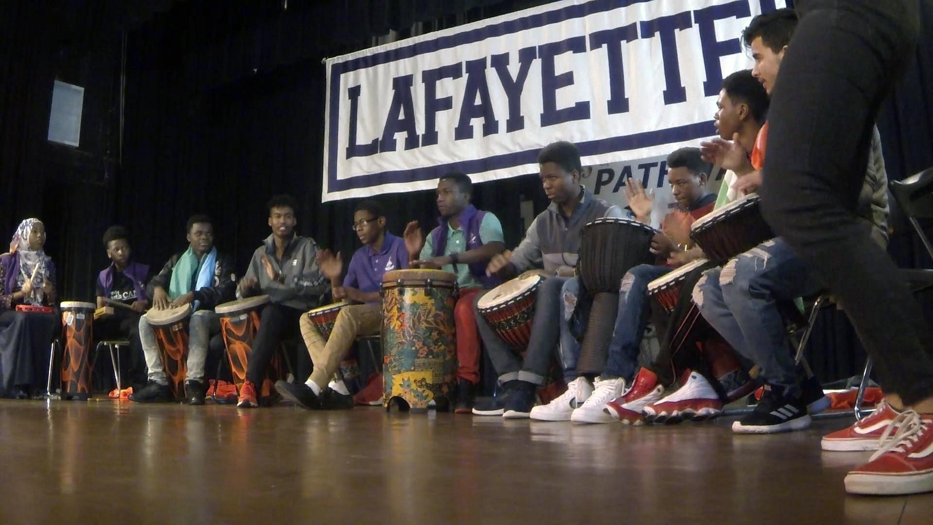 Kassim drums in the percussion and dance ensemble with his classmates