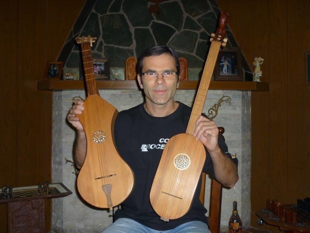 Daniel Yost posing with string instruments