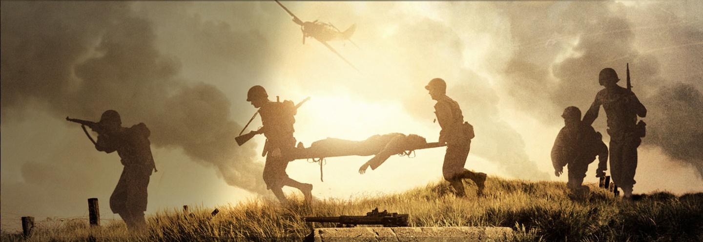 Soldiers in a battlefield carrying a wounded soldier