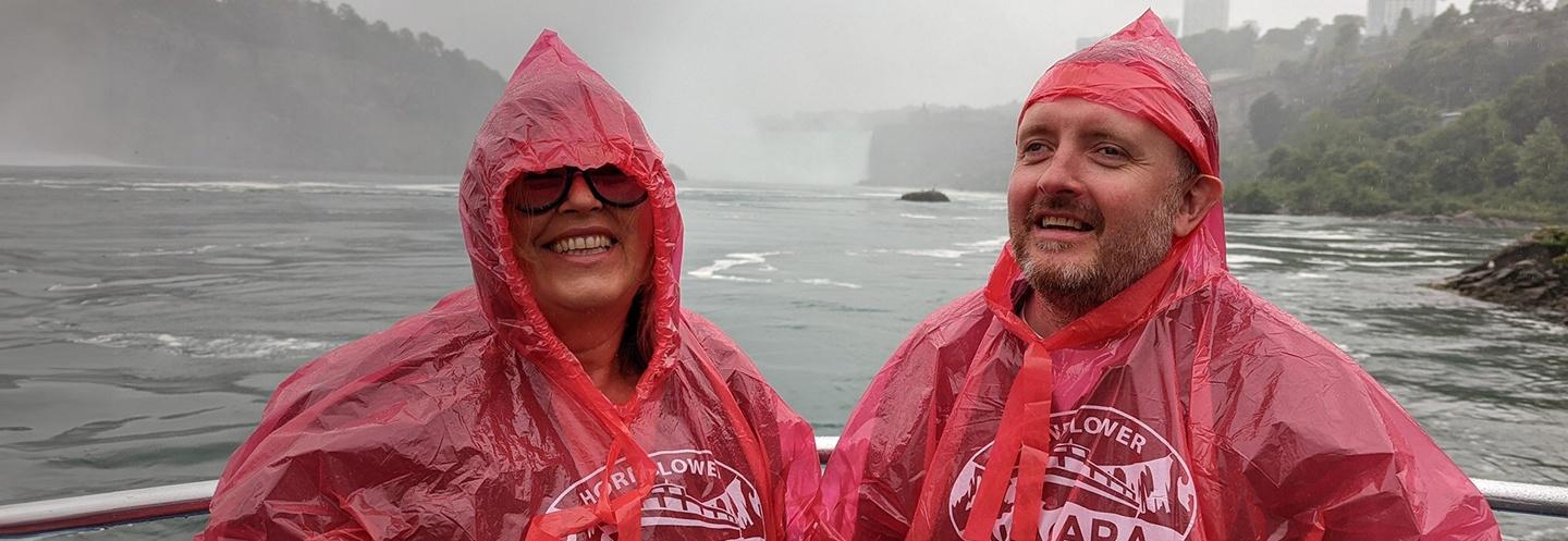 Liza Tarbuuck and Chris McCausland on a boat at the base of Niagara Falls