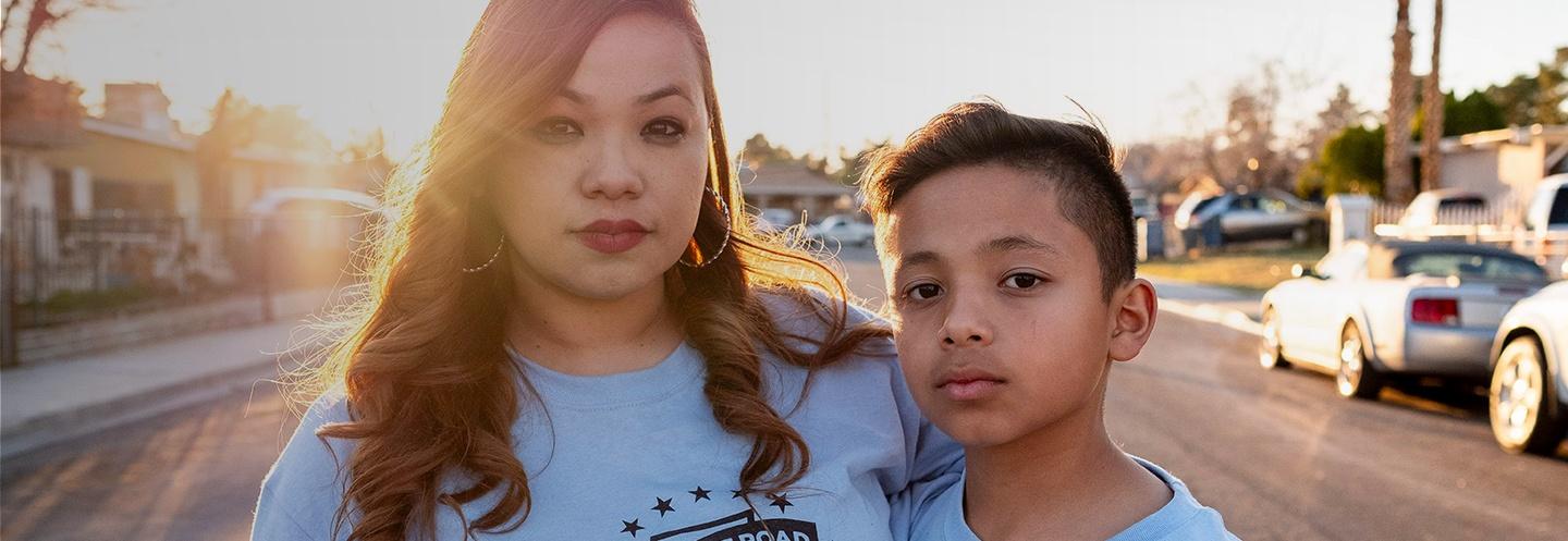 Photo of a mother and her son staring into the camera