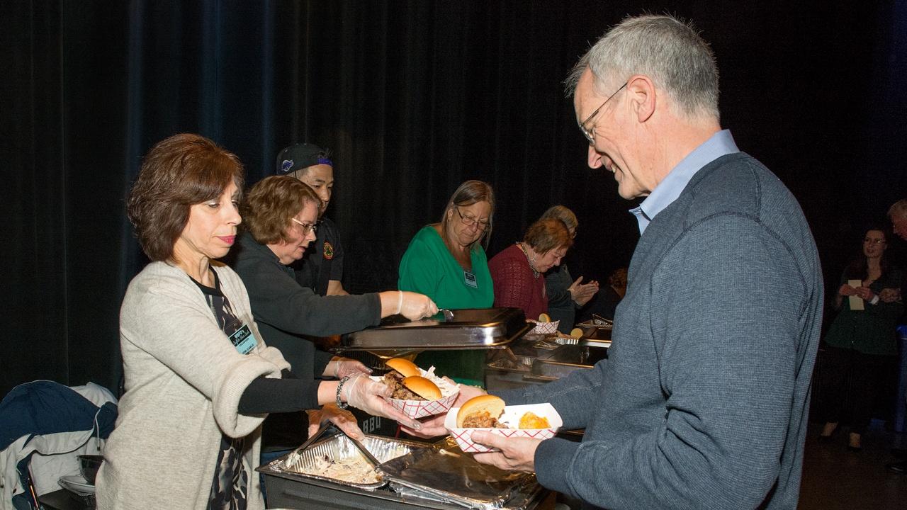 Volunteers serving food at WBFO's Buffalo Blues Bash