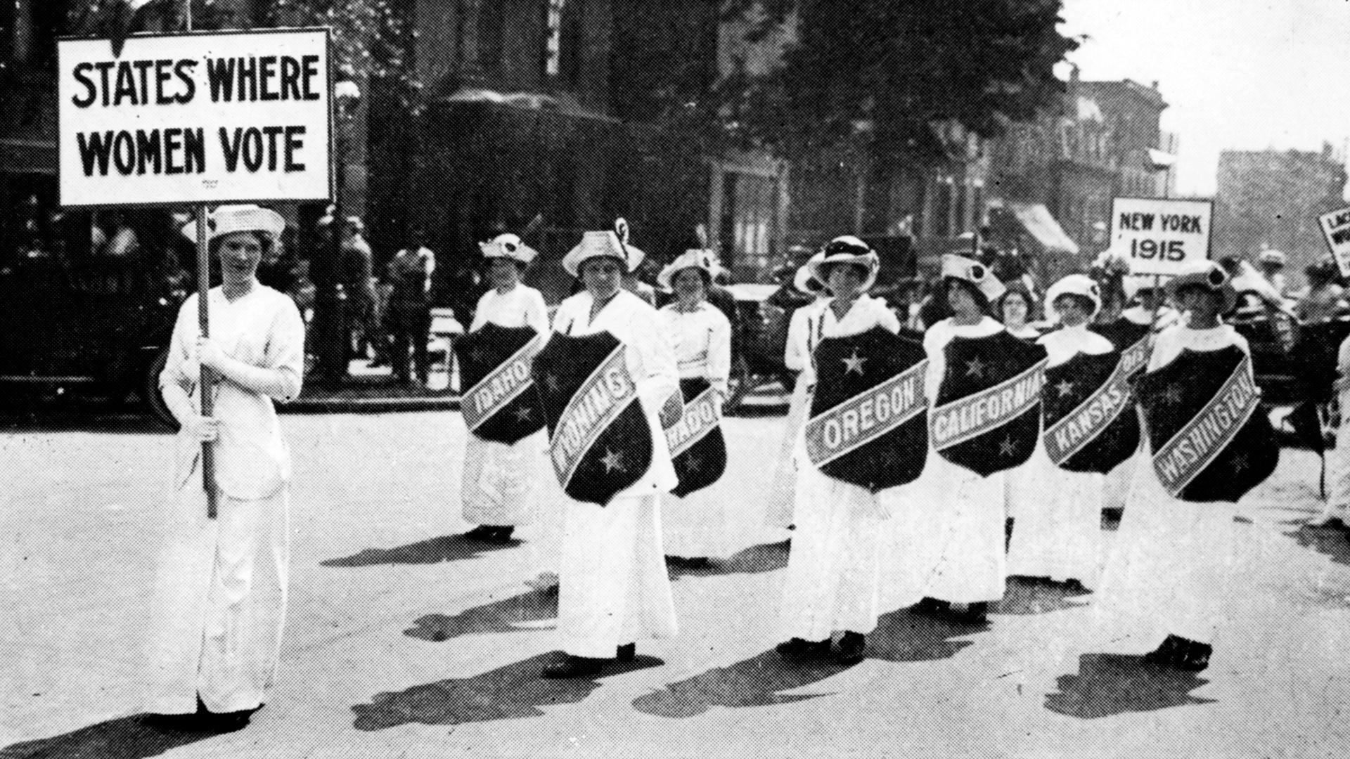 Suffrage was initially guaranteed at the state level. Women march in Buffalo in 1913 with signs recognizing states where women could vote.