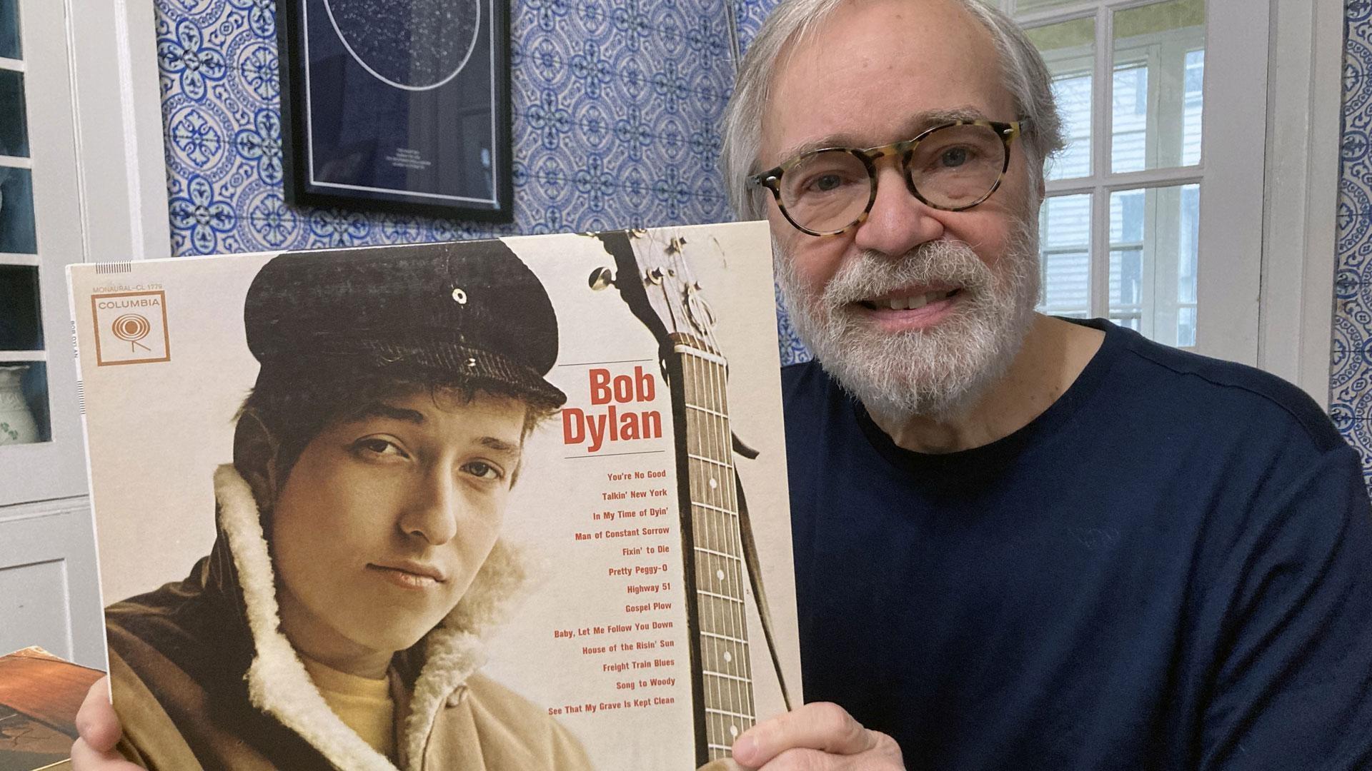 Michael McEntarfer holds up a Bob Dylan album