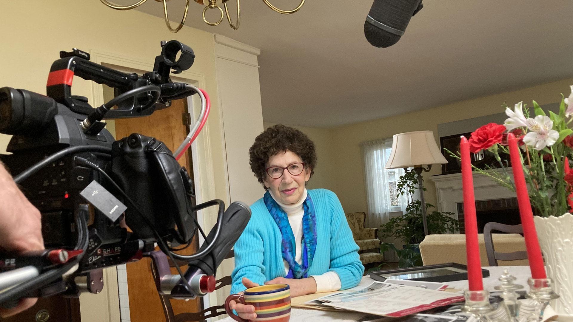 woman sitting at table waiting to be interviewed