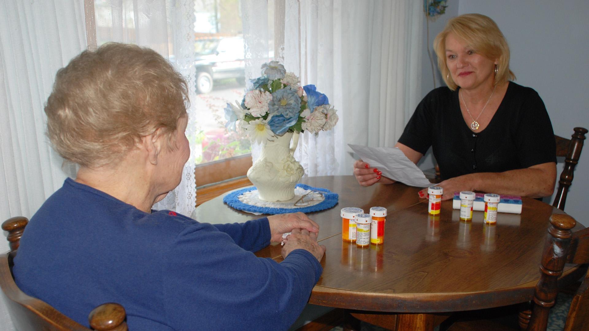 DAughter helping to organize her mother's medication