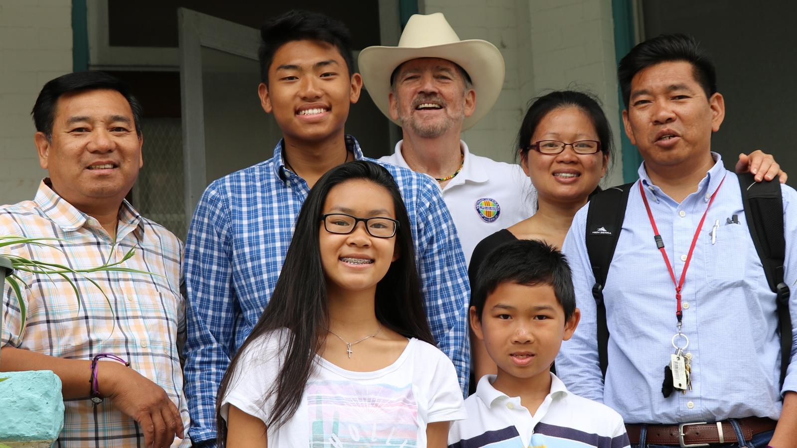 Brothers Minh and Tom Trân, their family, and Vietnam veteran Norm Murray.