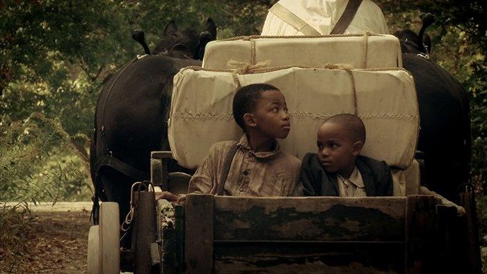 Still from the film: Sydney Still's sons in a horse-drawn wagon.