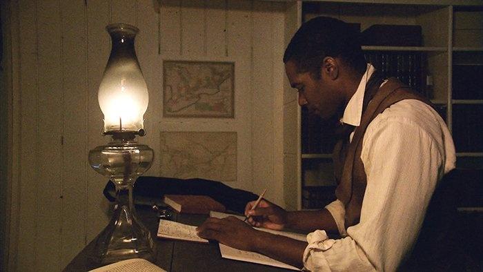 Still from the film: William Still writing in a book.