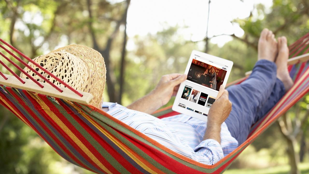 man in hammock viewing WNED PBS on his ipad