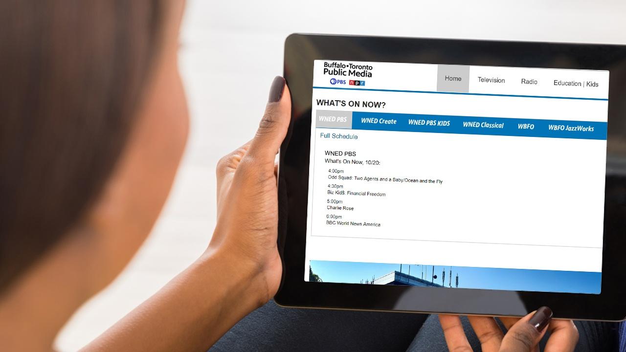 woman looking at the schedules for Buffalo Toronto Public Media on her ipad