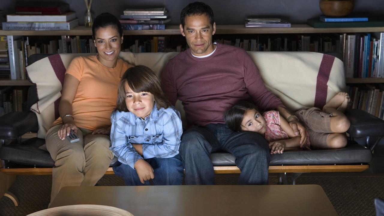 family on couch watching tv