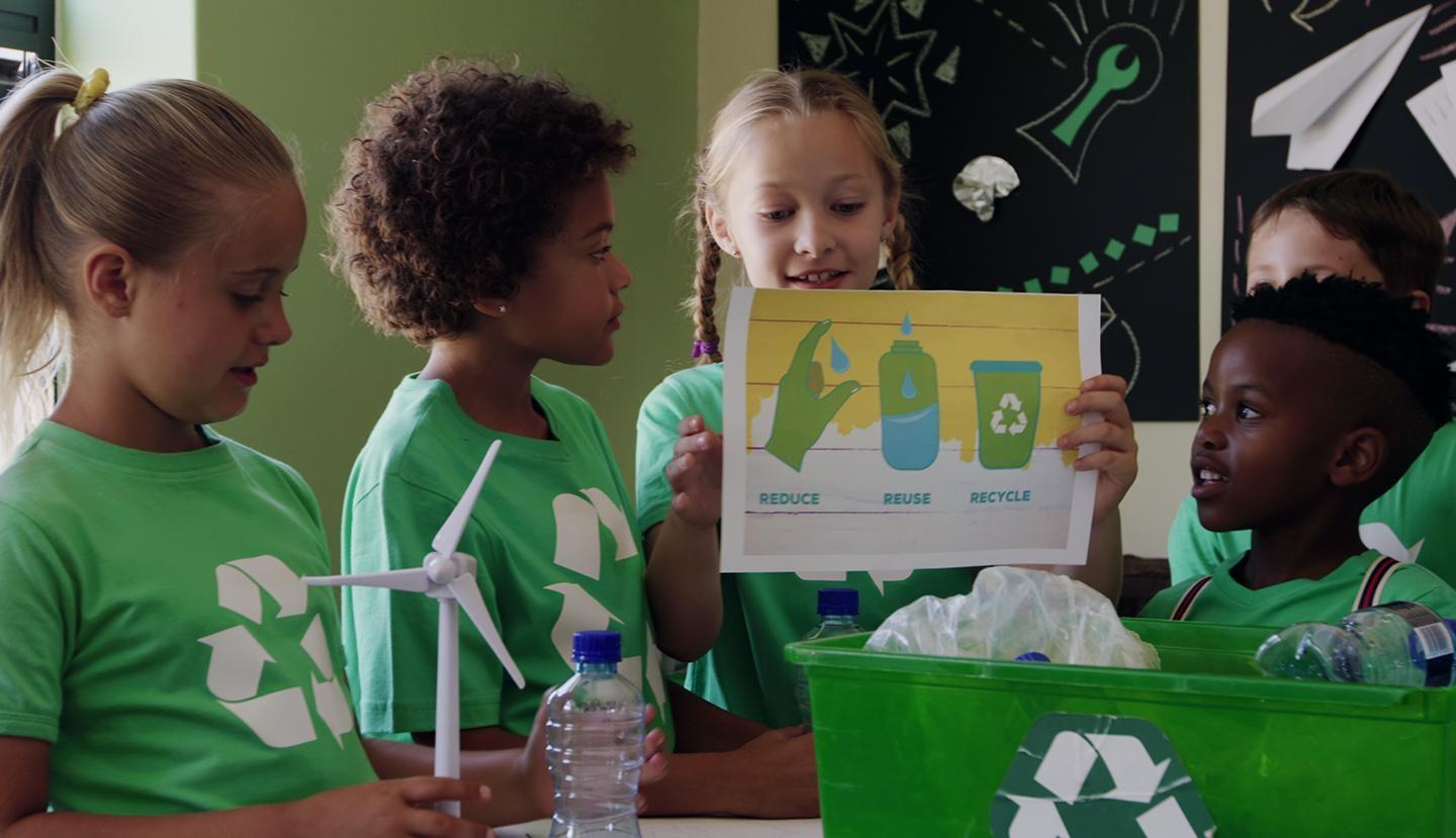 A group of kids learning about recycling