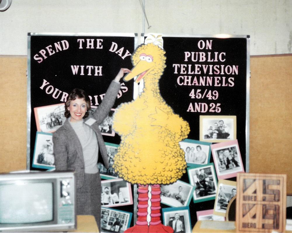 Educational Services employee Kathy Cybulski poses with Big Bird at a 1982 event.
