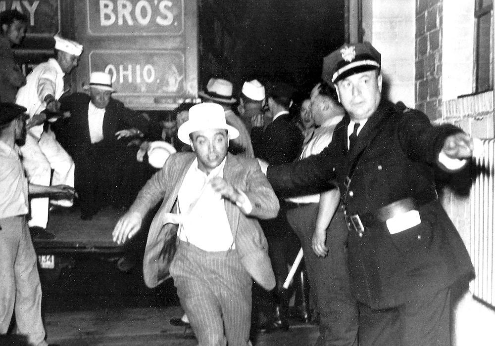 Kent police chief in 1936, St. Clair West, directs a frightened strikebreaker to the door to the jail.