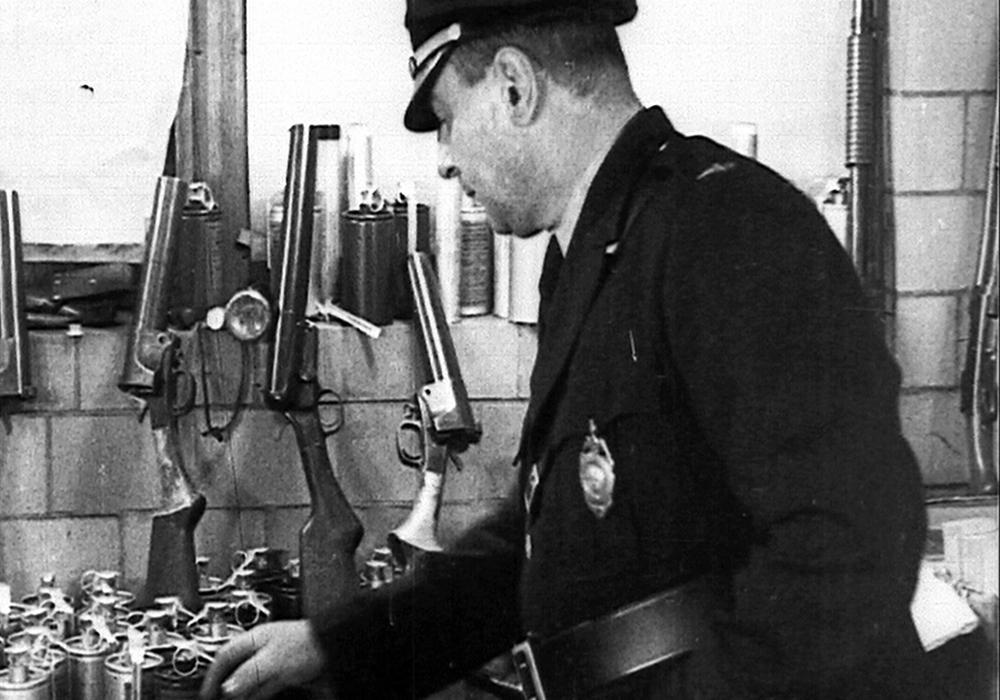 Kent police chief in 1936, St. Clair West, examines some of the weapons confiscated from strikebreakers in the Black & Decker plant.